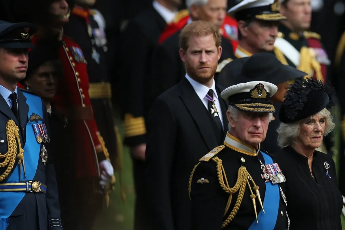 Prince William, Prince Harry, King Charles III, and Queen Camilla look on during the state funeral for Queen Elizabeth II