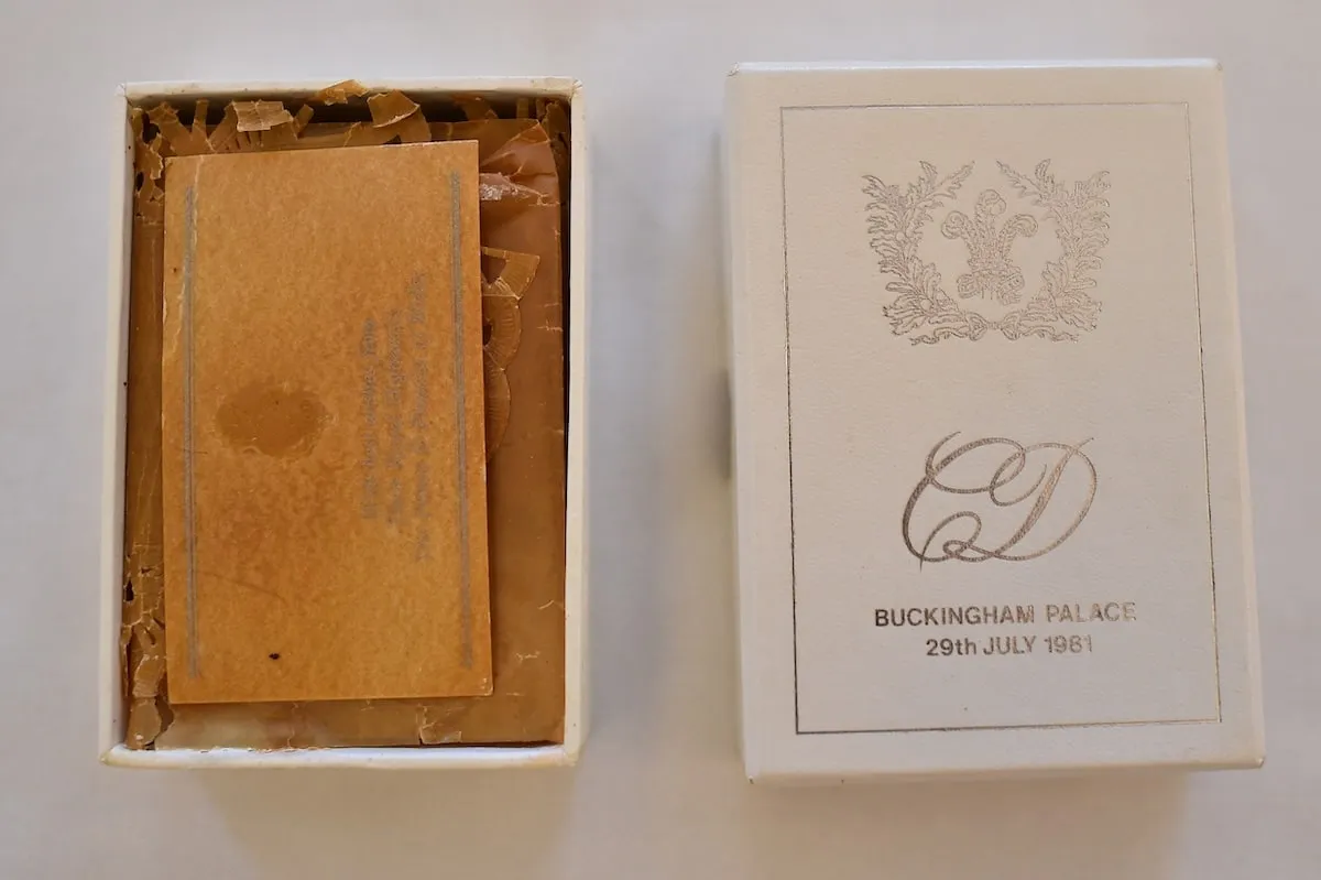 A slice of Princes Charles and Princess Diana's wedding cake is preserved in a box