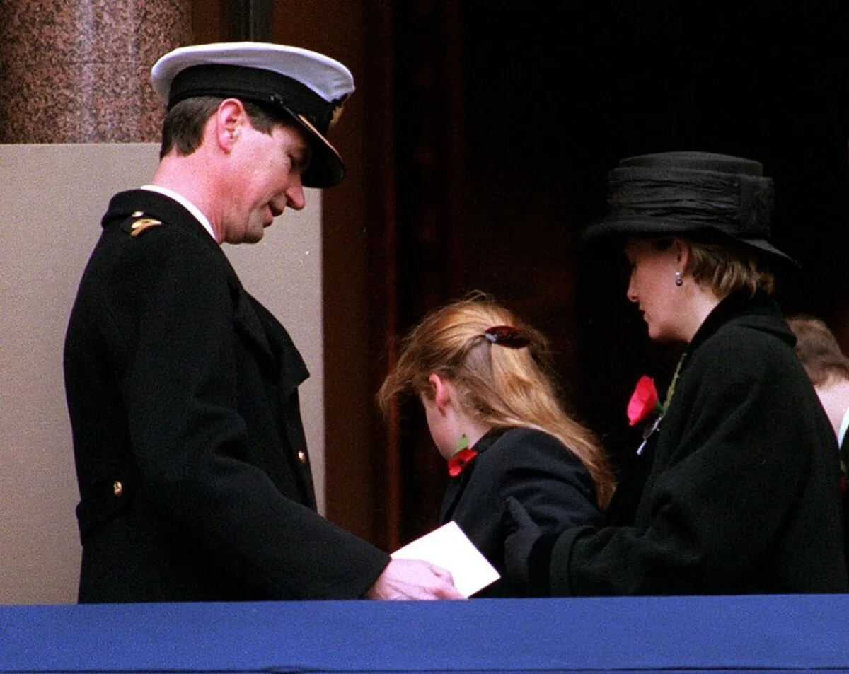 Princess Beatrice helped to her feet by the then-Countess of Wessex after appearing to faint during the Remembrance Service in Whitehall