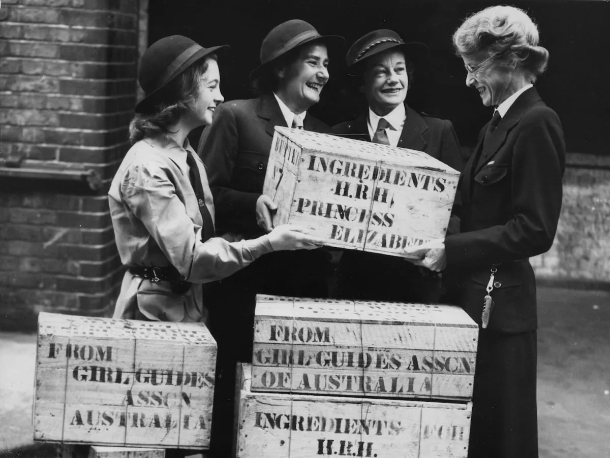 Queen Elizabeth's secretary receives a gift of ingredients for Princess Elizabeth's wedding cake, presented by three Australian Girl Guides