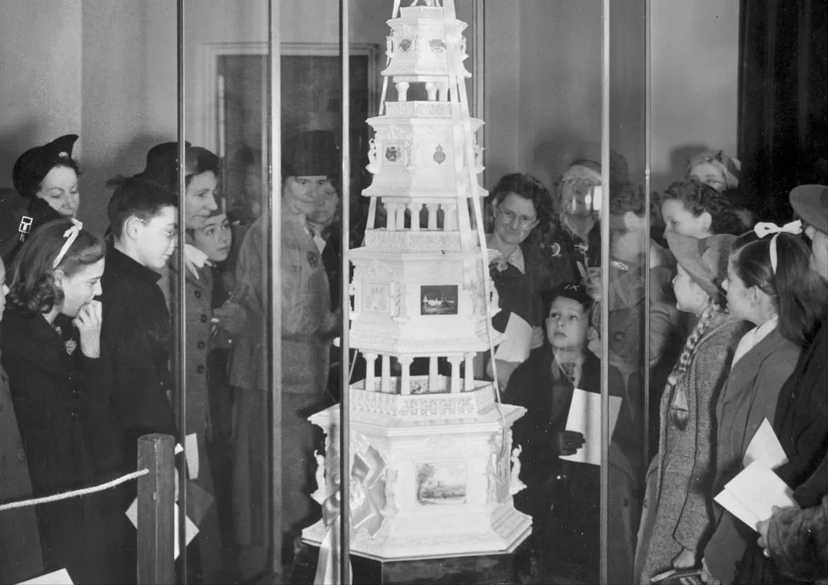 Visitors to the Huntley and Palmer factory in Reading, Berkshire, view a replica of the royal wedding cake