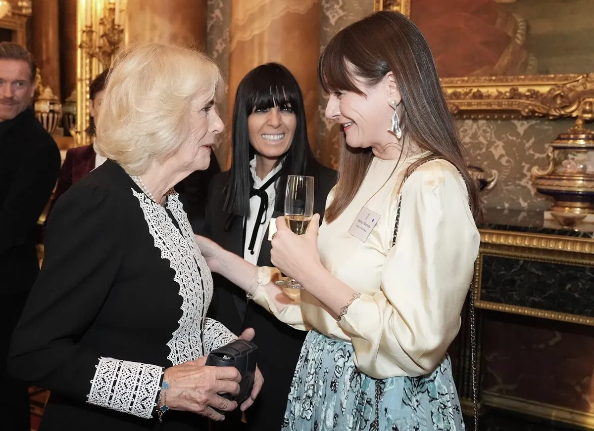 Queen Camilla speaks to Emily Mortimer during a reception to mark the centenary of the Film and TV charity at Buckingham Palace