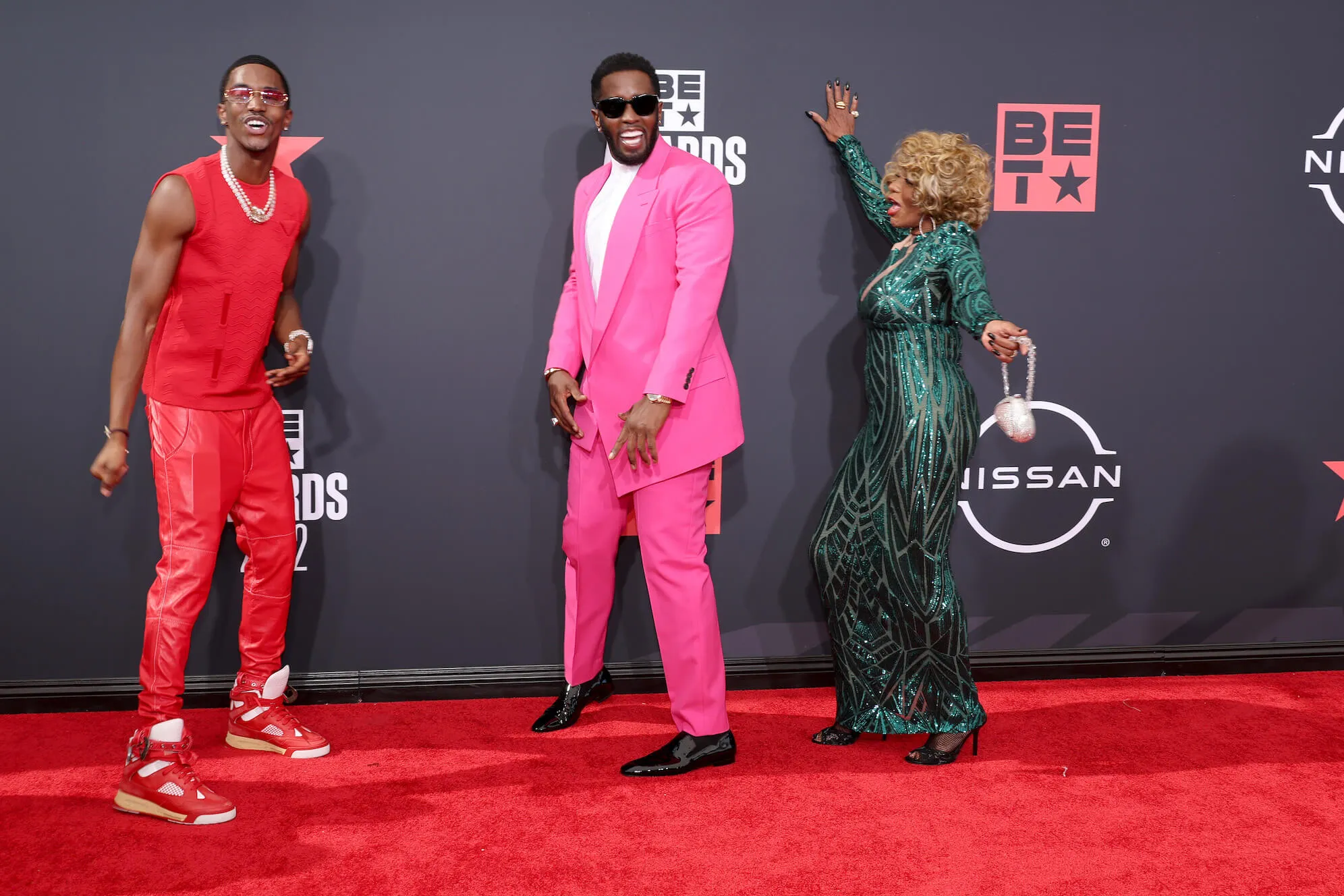 Christian 'King' Combs, Sean 'Diddy' Combs and Janice Combs posing and laughing on the red carpet in 2022