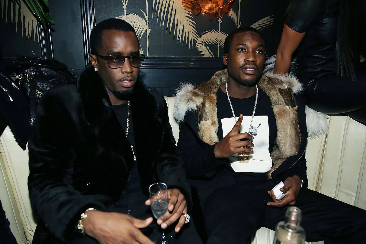 Sean 'Diddy' Combs and Meek Mill sitting next to each other at an afterparty in 2014