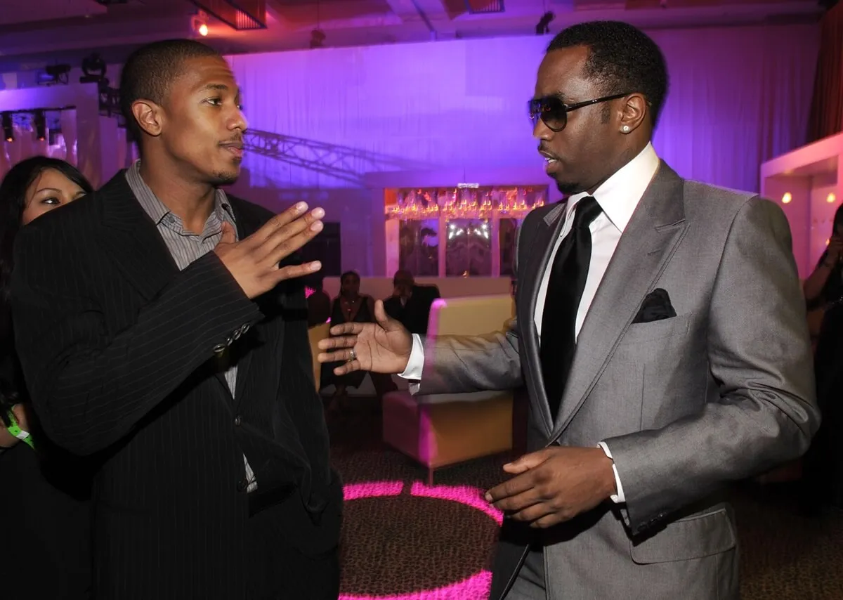 Nick Cannon and Sean Diddy Combs about to shake hands at a party.