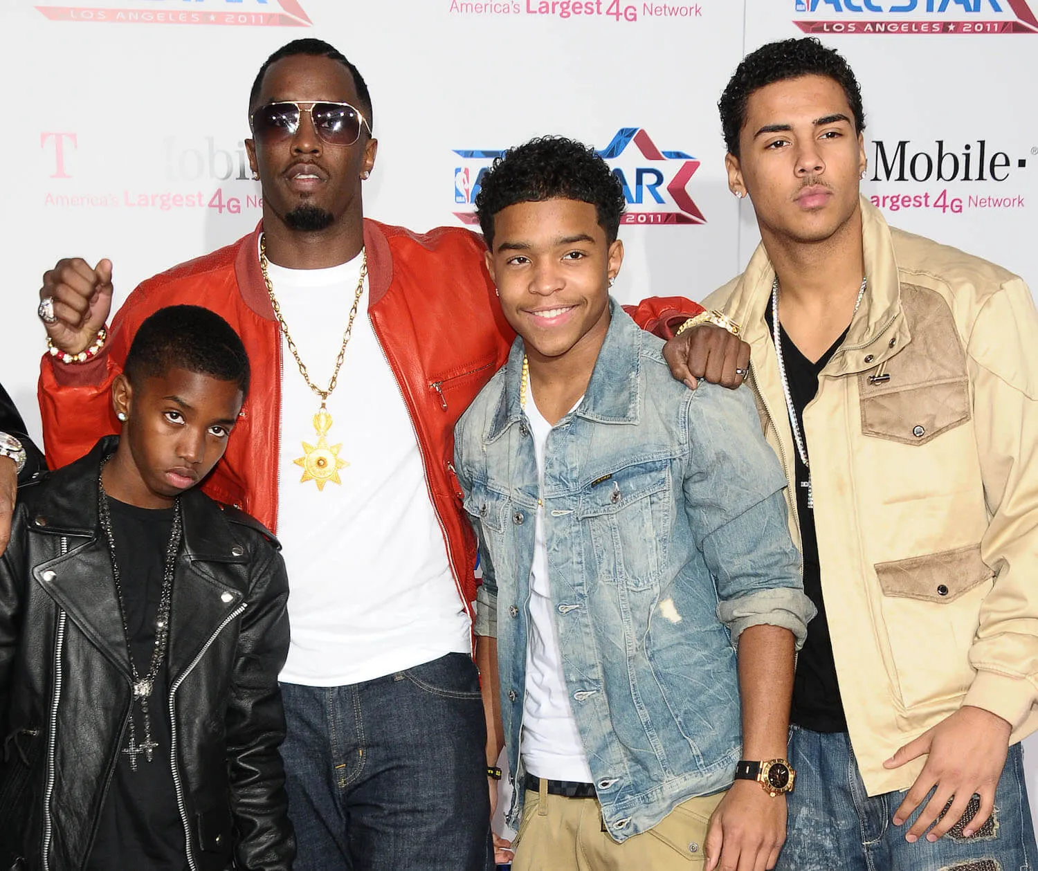 Christian Combs, Sean 'Diddy' Combs, Justin Combs, and Quincy Jones Brown posing together in 2011