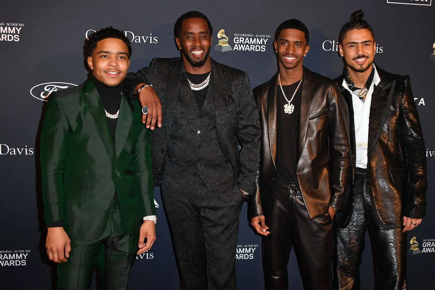 Justin Dior Combs, Sean 'Diddy' Combs, Christian Combs, and Quincy Taylor Brown posing with each other at a Grammy event