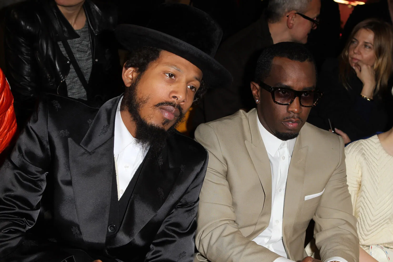 Jamal 'Shyne' Barrow and Sean 'Diddy' Combs sitting next to each other at a fashion show in 2012