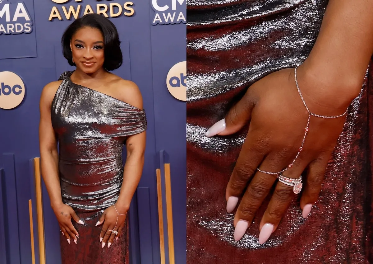 Wearing a silver gown, Simone Biles poses on the red carpet before the CMA Awards