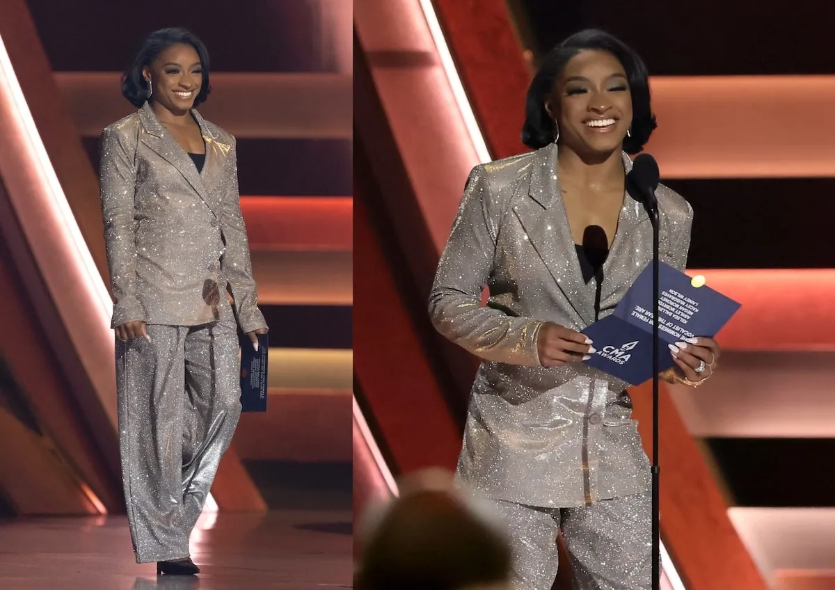 Wearing a sparkly, silver suit, Simone Biles speaks onstage during The 58th Annual CMA Awards