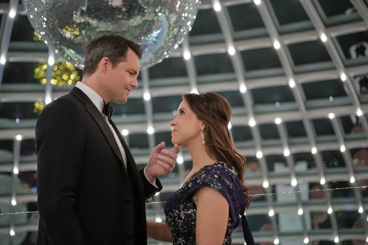 Kristoffer Polaha holding Lacey Chabert's chin in his hand in 'The Christmas Quest' on Hallmark Channel