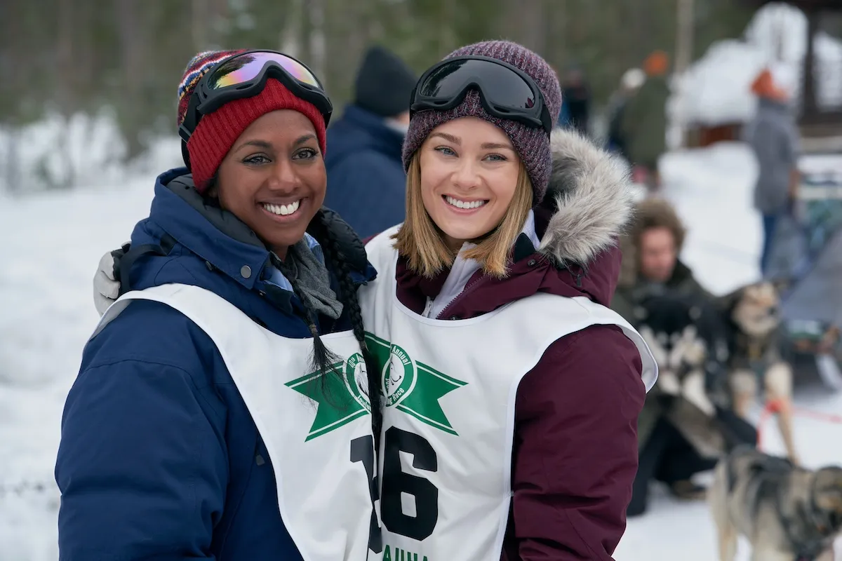 A Black woman and a white woman smiling in outdoor gear in 'The Finnish Line' on Hallmark Channel