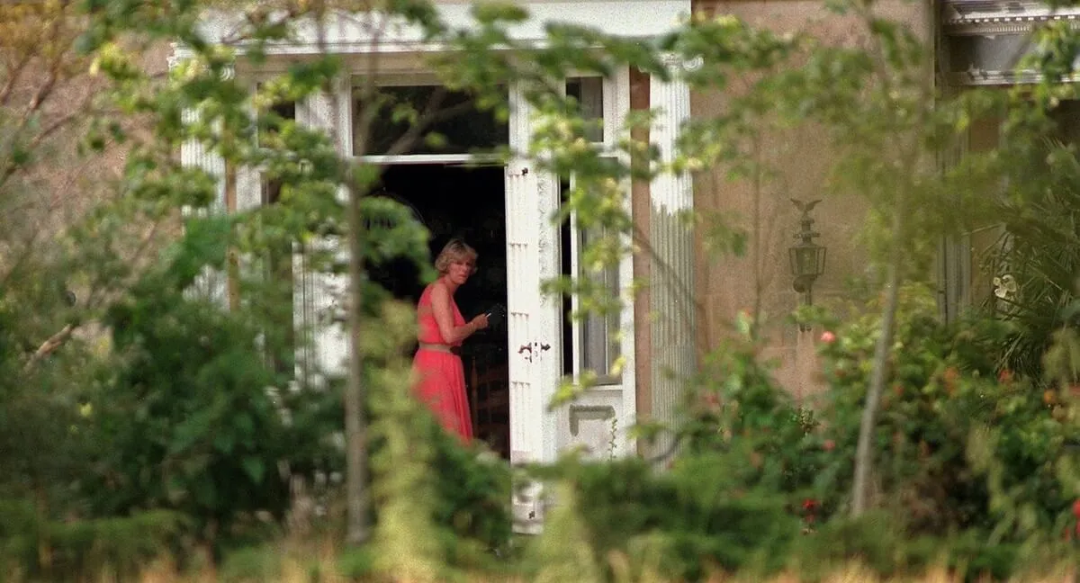 Then known as Camilla Parker Bowles smoking a cigarette at the door of her Reybridge Mills home