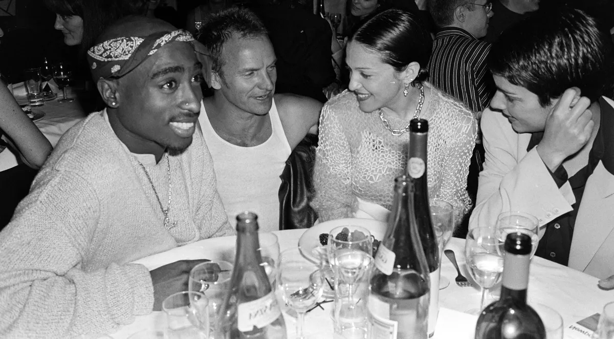 Tupac Shakur, Sting, Madonna, and Ingrid Casares are seen together at a 1990s dinner party