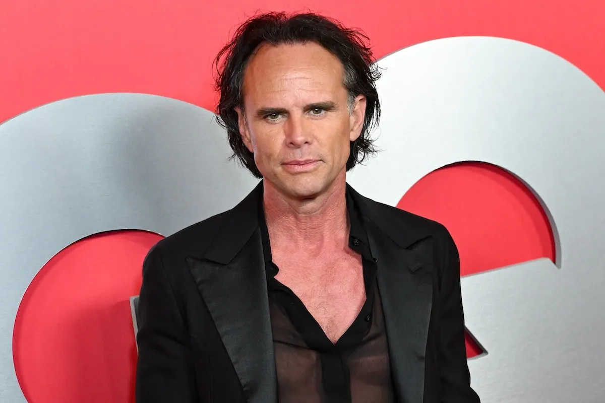 Wearing a black jacket and shirt, Walton Goggins poses for photos on the red carpet at the 2024 GQ Men Of The Year Party