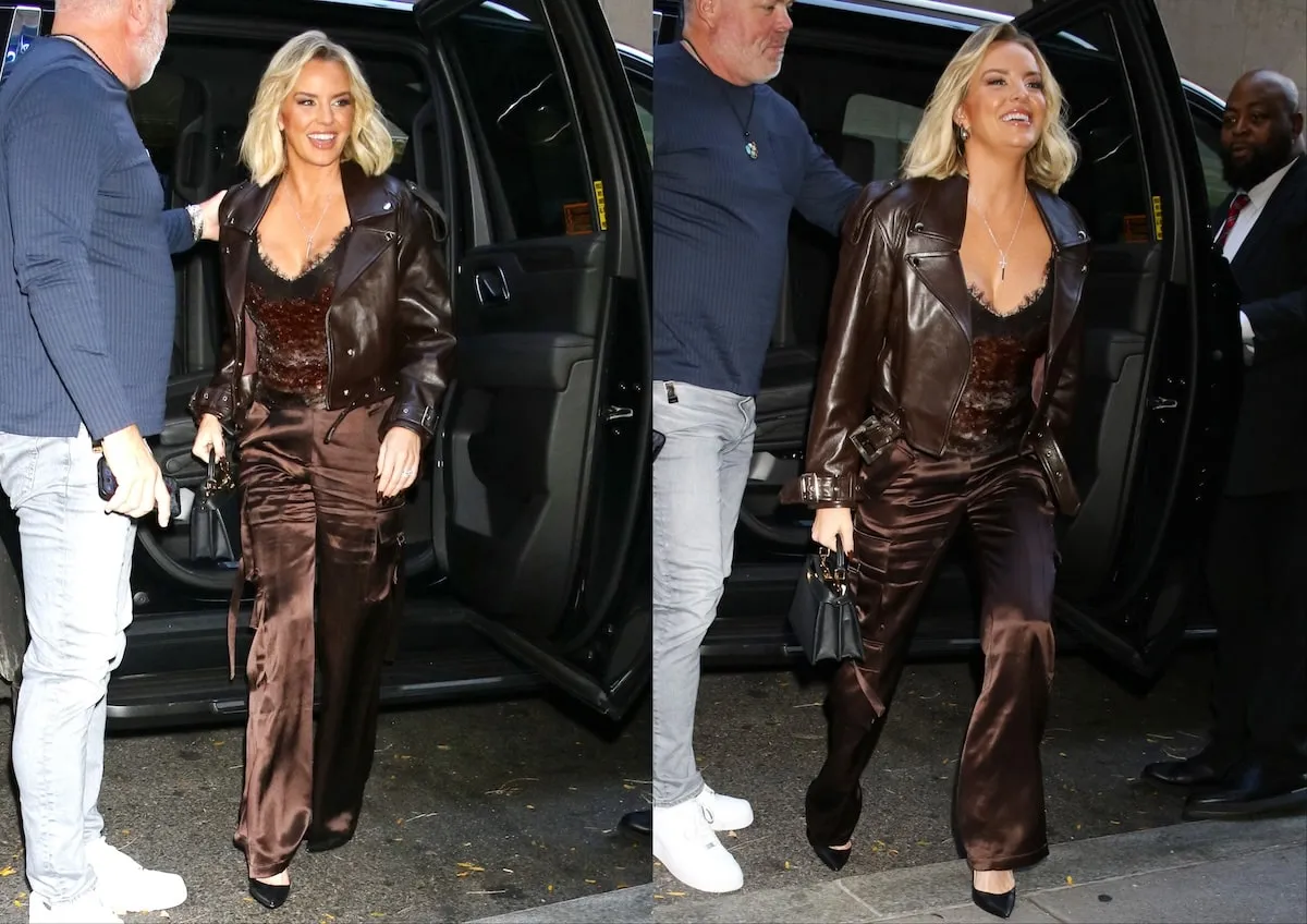 Wearing a chocolate brown tank top and cargo pants, Whitney Rose smiles for paparazzi as she enters a high-rise in New York City