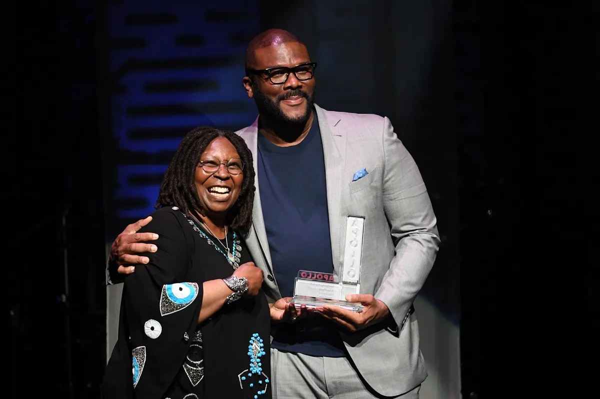 Whoopi Goldberg presents an award to Tyler Perry during the Apollo Theater Spring Benefit.