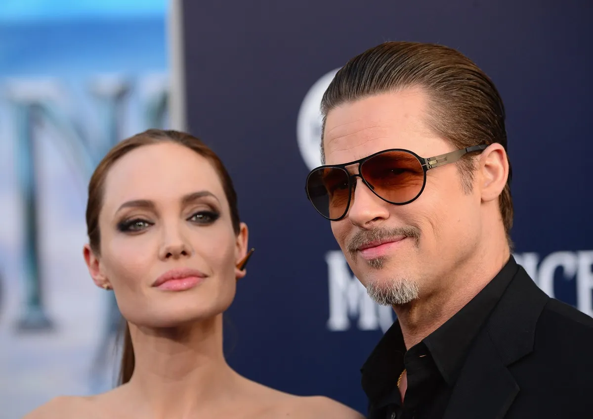 Angelina Jolie posing in a dress alongside Brad Pitt at the World Premiere Of Disney's 'Maleficent'.