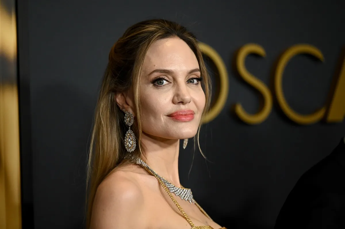 Angelina Jolie posing in a dress while at the Governor Awards.