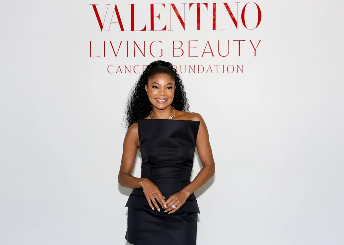 Gabrielle Union posing in a black dress at the Living Beauty Spring Luncheon and Fundraiser with Valentino