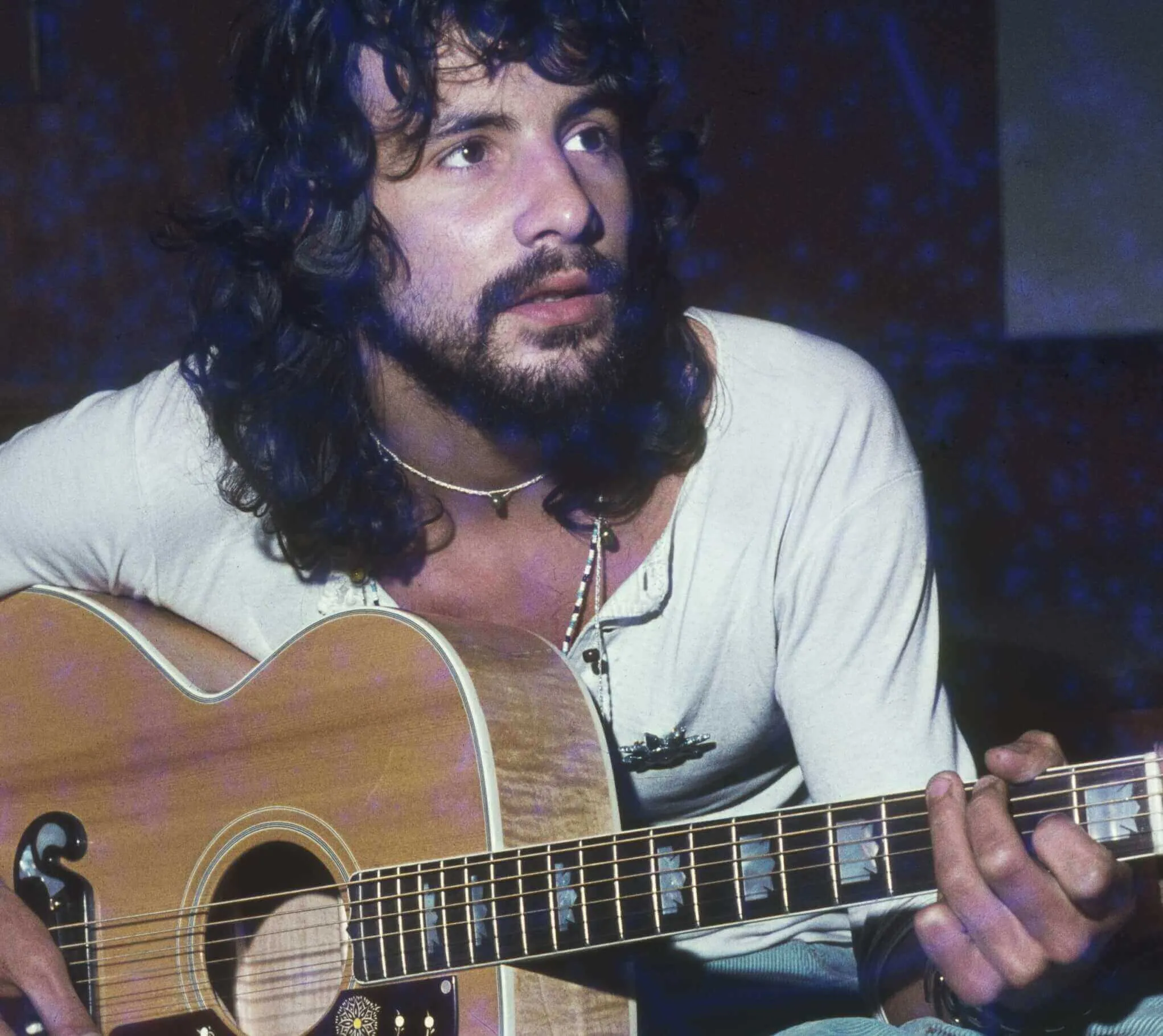 "Wild World" singer Cat Stevens with a guitar