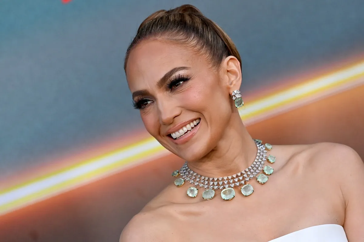 Jennifer Lopez smiling while wearing a dress.