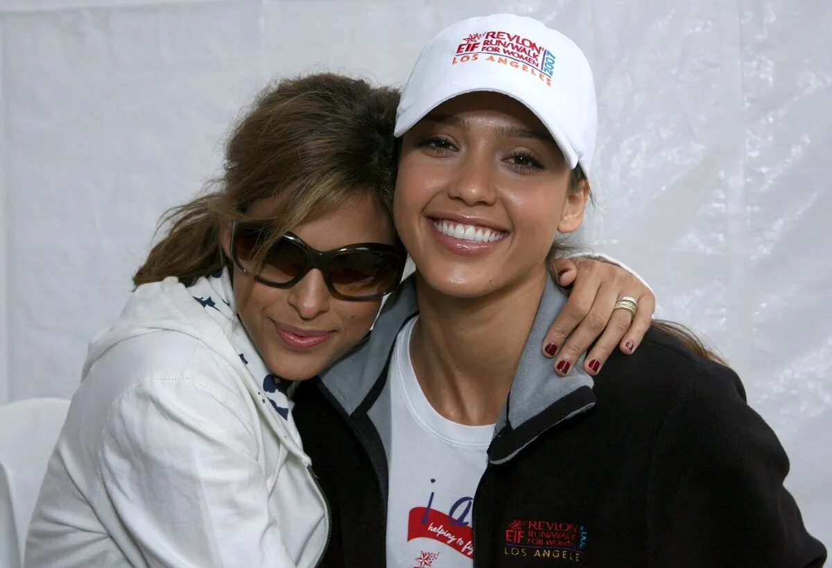 Jessica Alba smiling alongside Eva Mendes at the 14th Annual Revlon Run/Walk for Women at Los Angeles Memorial Coliseum at Exposition Park.