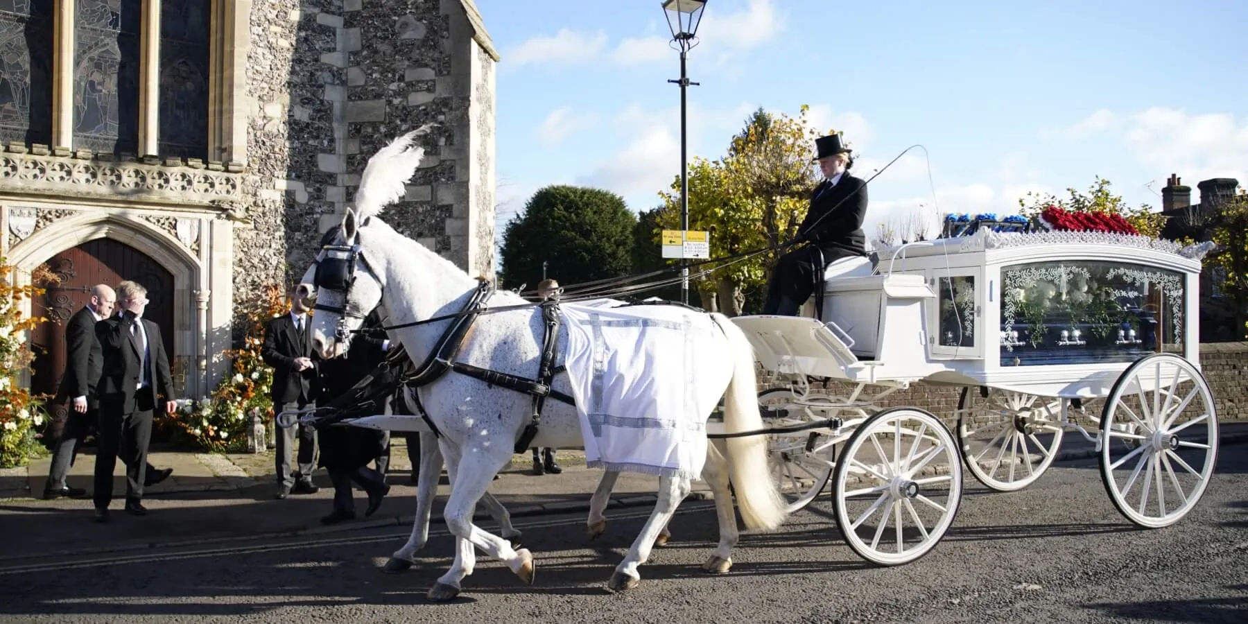 Liam Payne's body arrives at church in a horse-drawn carriage.