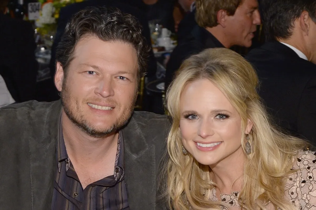 Blake Shelton smiling next to Miranda Lambert at the 2014 MusiCares Person Of The Year Honoring Carole King.