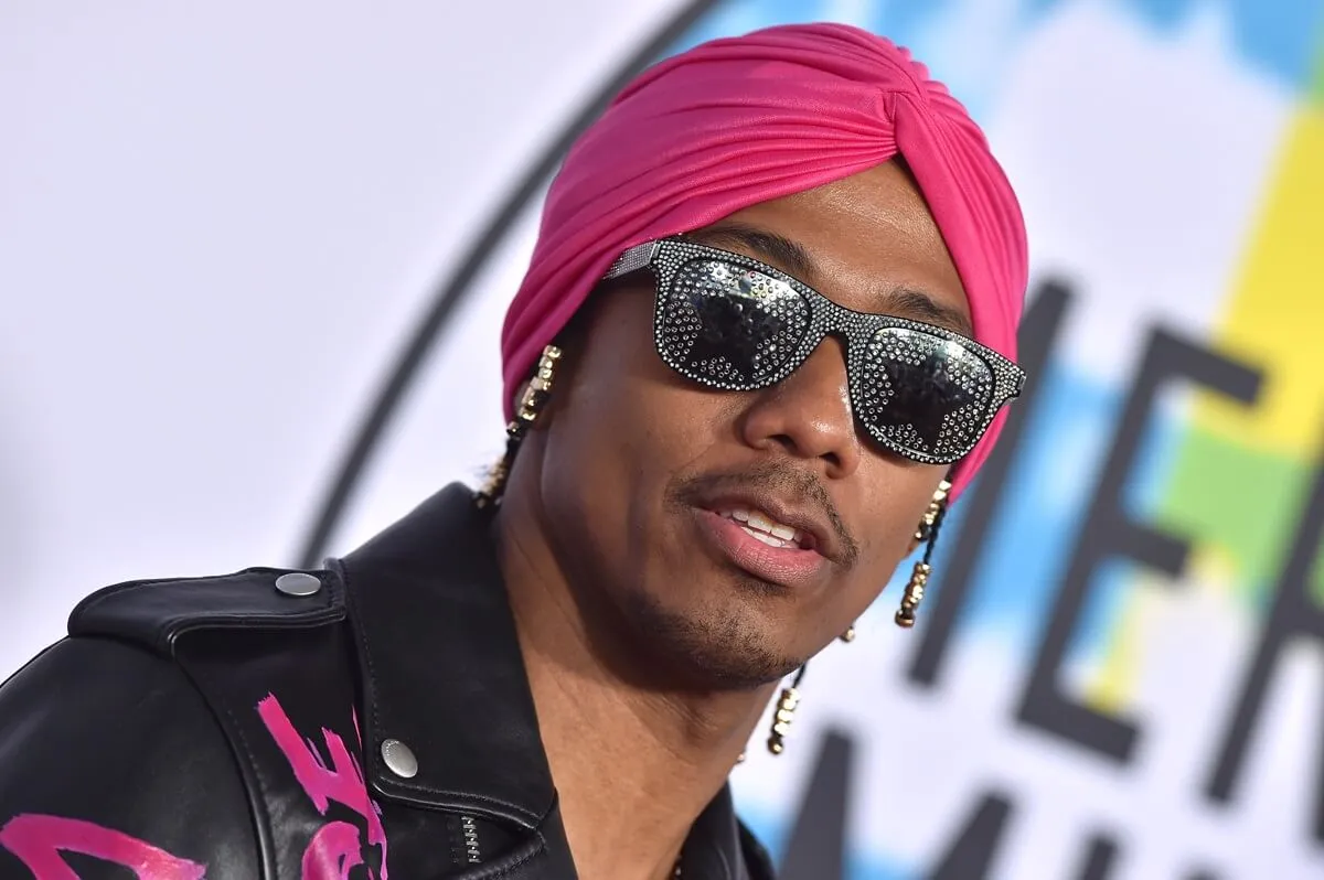 Nick Cannon arrives at the 2017 American Music Awards at Microsoft Theater wearing a black and pink outfit.