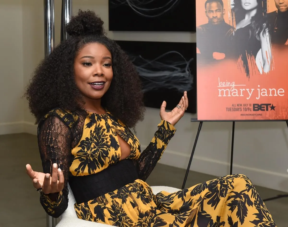 Gabrielle Union in a yellow and black dress at a 'Being Mary Jane' press event.