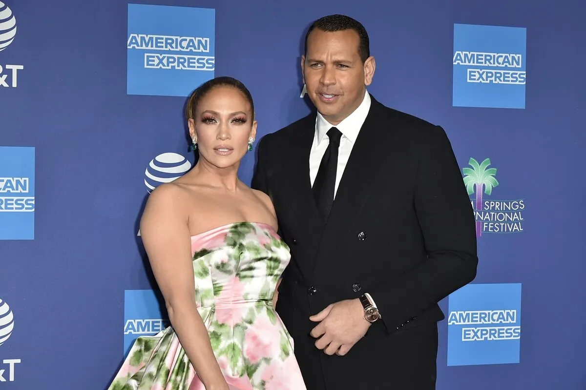 Jennifer Lopez in a dress posing next to Alex Rodriguez who's in a suit at the Annual Palm Springs International Film Festival Gala.