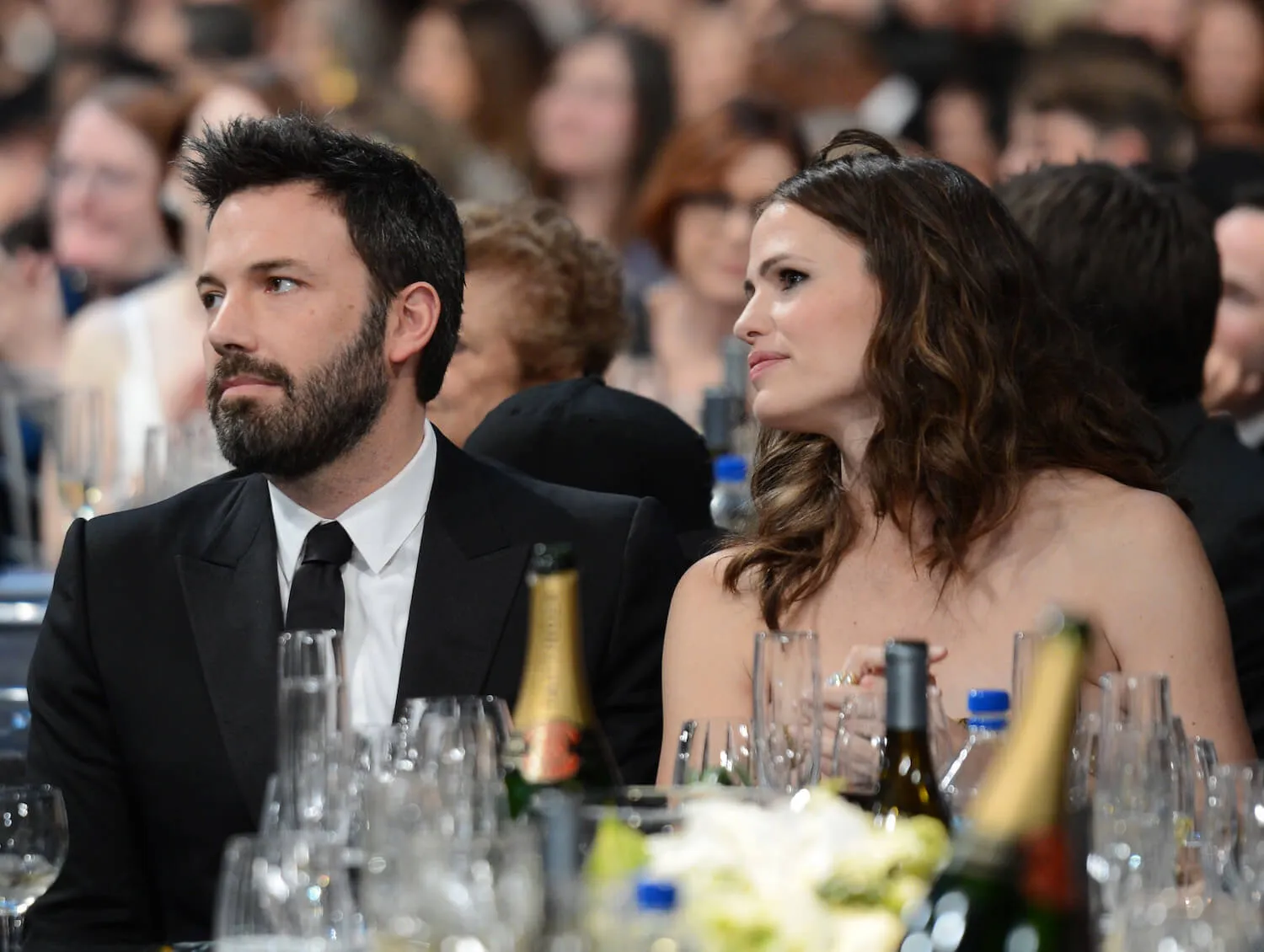 Ben Affleck and Jennifer Garner looking over their right shoulder while sitting at a table at the 19th Annual Screen Actors Guild Awards