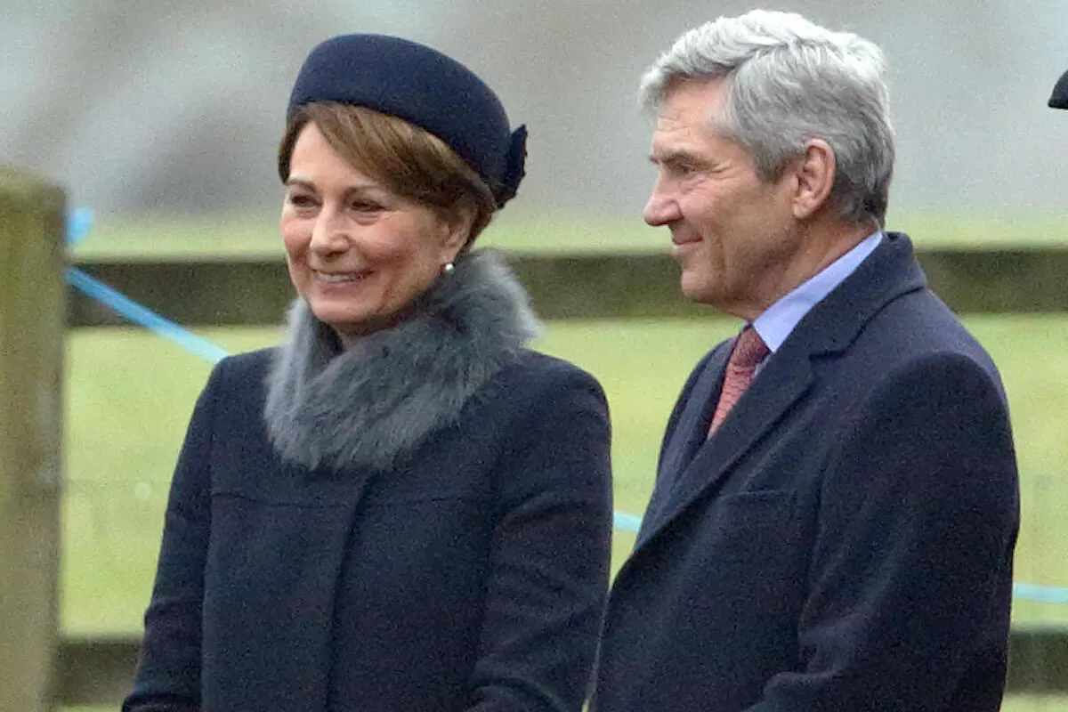 Carole and Michael Middleton stand next to each other at Sandringham