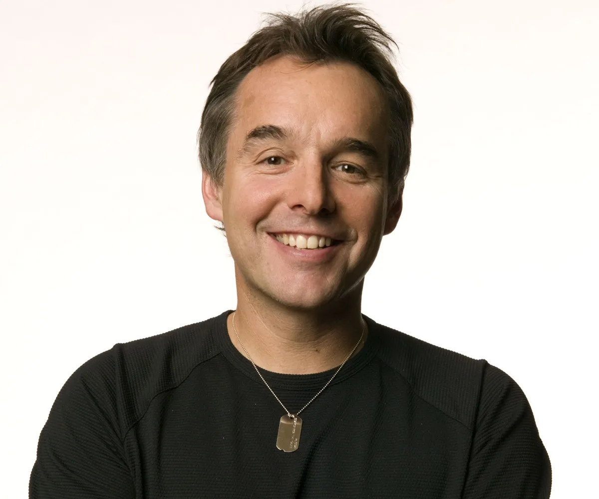 Director Chris Columbus in a promotional portrait for the Search for the Cause campaign, which raises funds for cancer research. He wears a Search for the Cause dogtag.