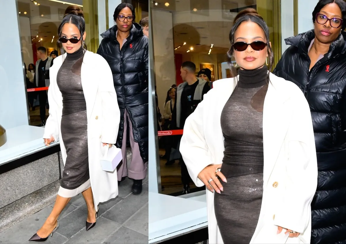 Wearing a black dress and white coat, Christina Milian dodges the paparazzi in NYC in 2024