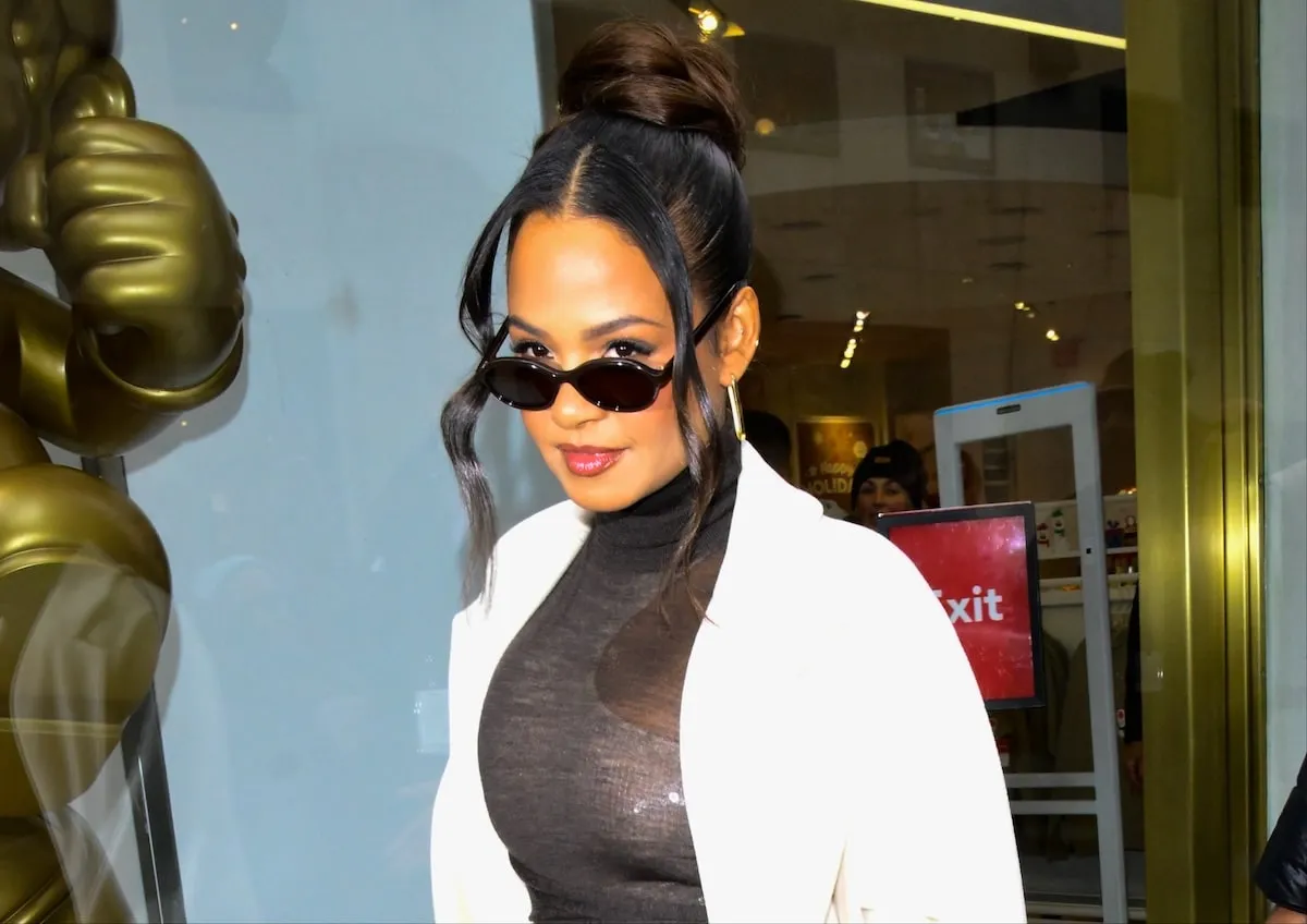 Wearing a black dress and white coat, Christina Milian dodges the paparazzi in NYC in 2024