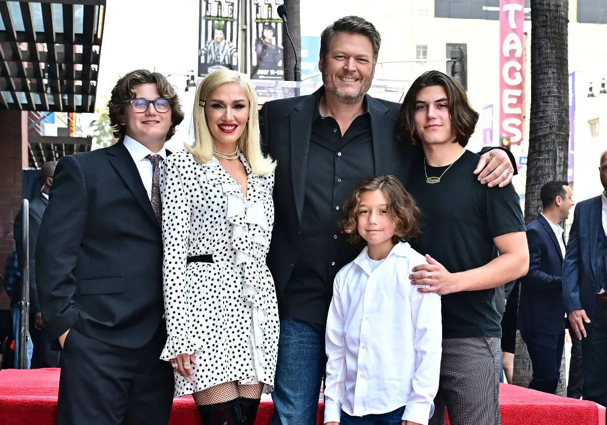 Gwen Stefani and Blake Shelton stand with their children. 