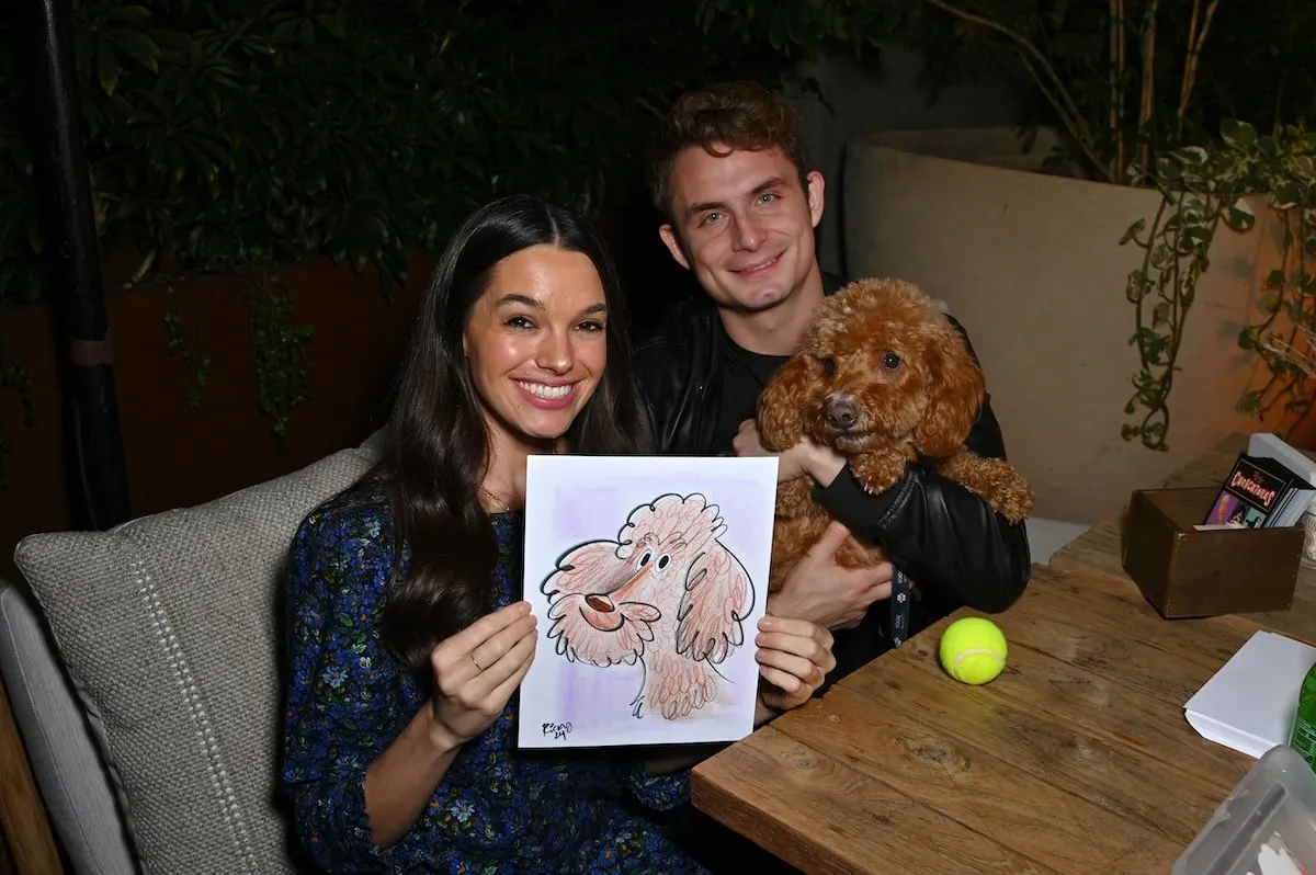 Smiling together, Ally Lewber and James Kennedy take photos with their goldendoodle Hippie at Dogsgiving with REÁL MESA