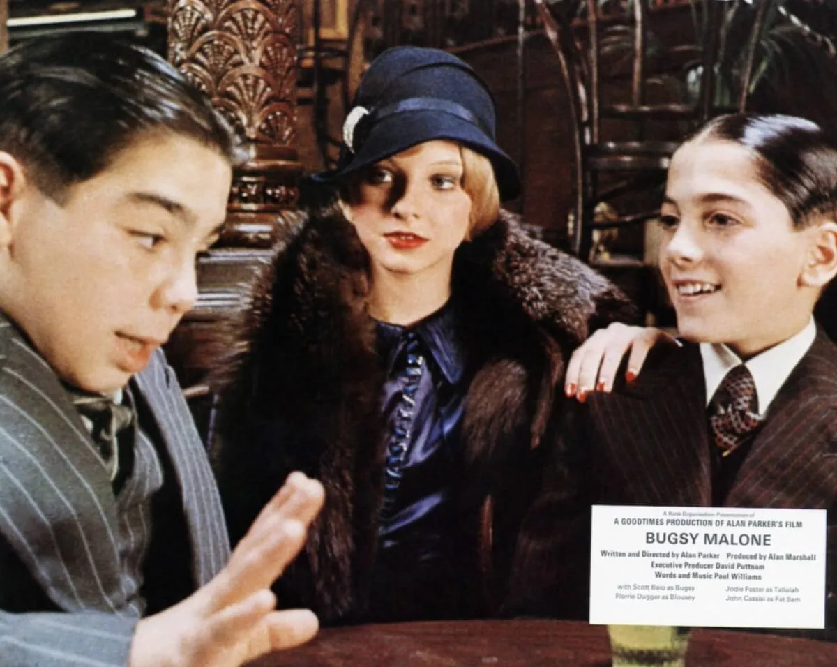 Young Jodie Foster, dressed in 1920s fashion, standing between John Cassisi and Scott Baio in 'Bugsy Malone'