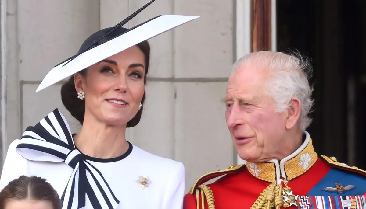 Kate Middleton and King Charles III speaking while standing on the balcony of Buckingham Palace during Trooping the Colour