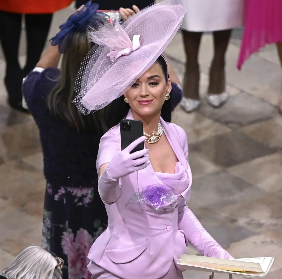 Katy Perry takes selfies as she attends the coronation of King Charles III