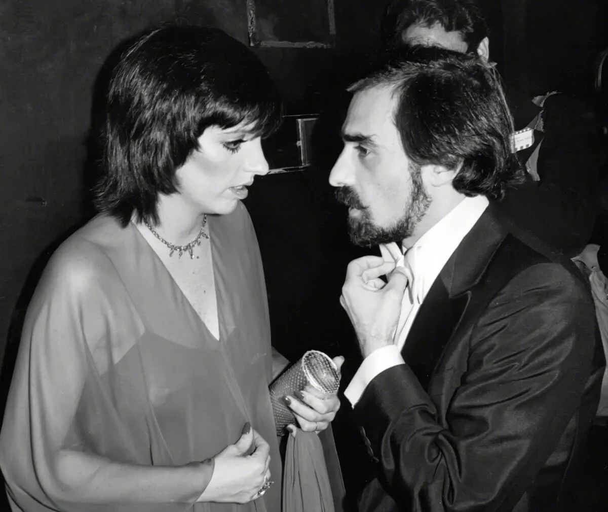 A black and white picture of Liza Minnelli and Martin Scorsese speaking to each other.