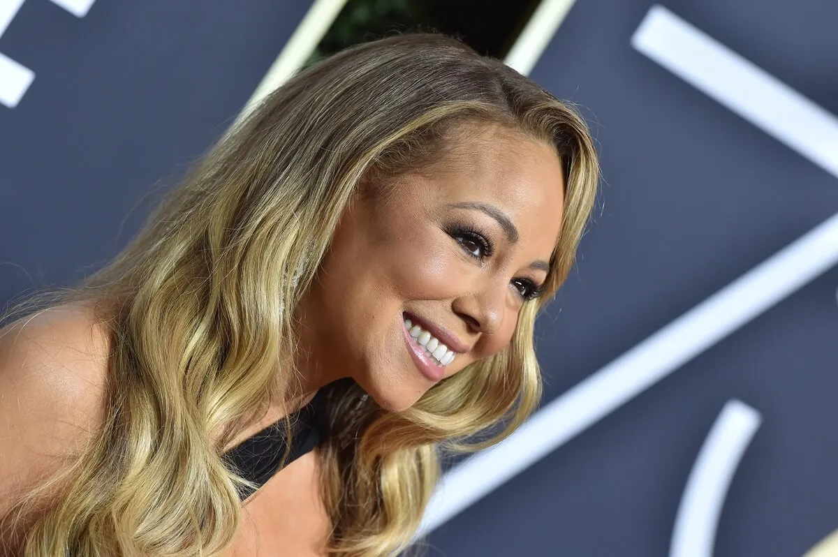 Mariah Carey posing at the 75th Annual Golden Globe Awards in a dress.