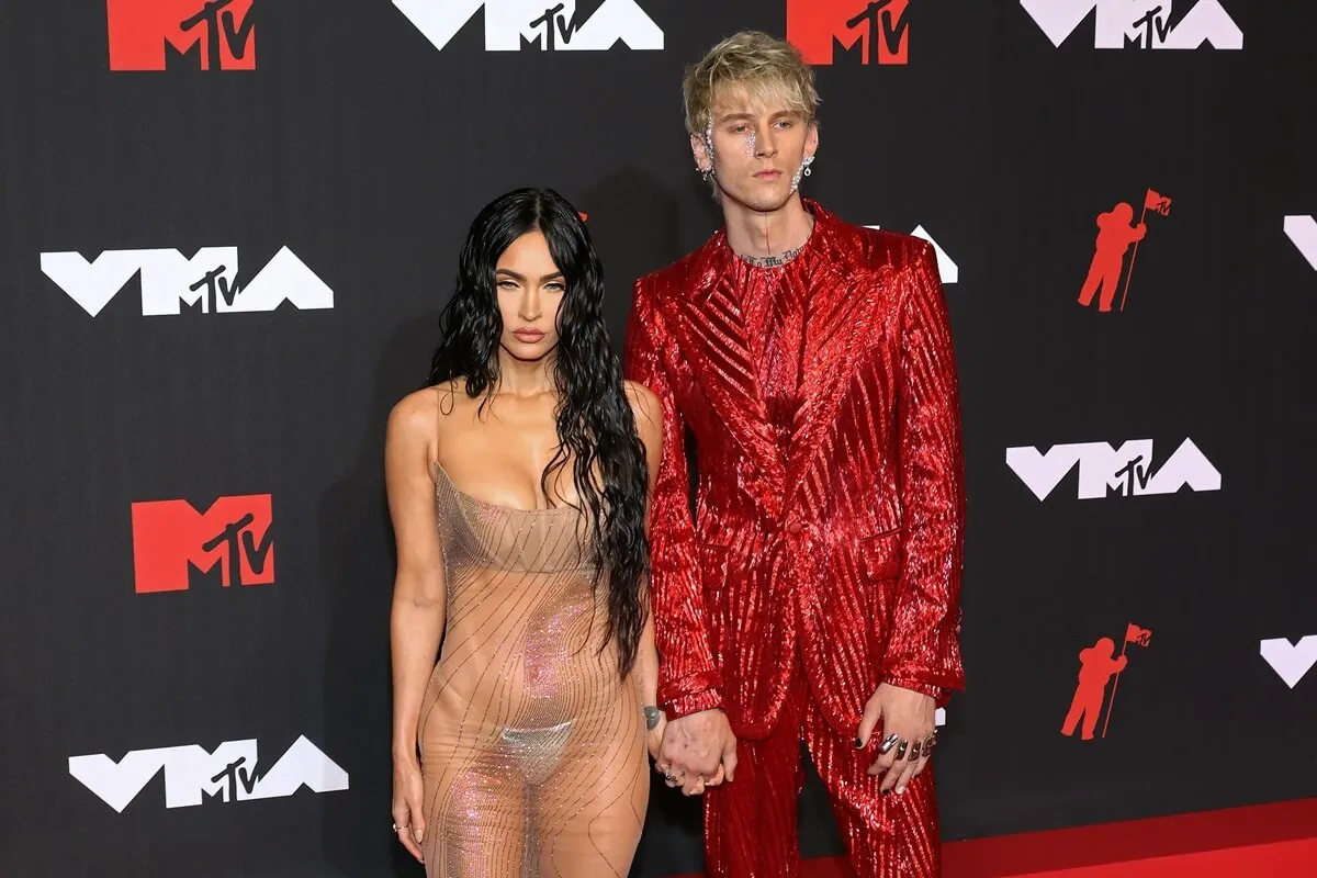 Megan Fox and Machine Gun Kelly attend the 2021 MTV Video Music Awards at Barclays Center in a dress and suit respectively.