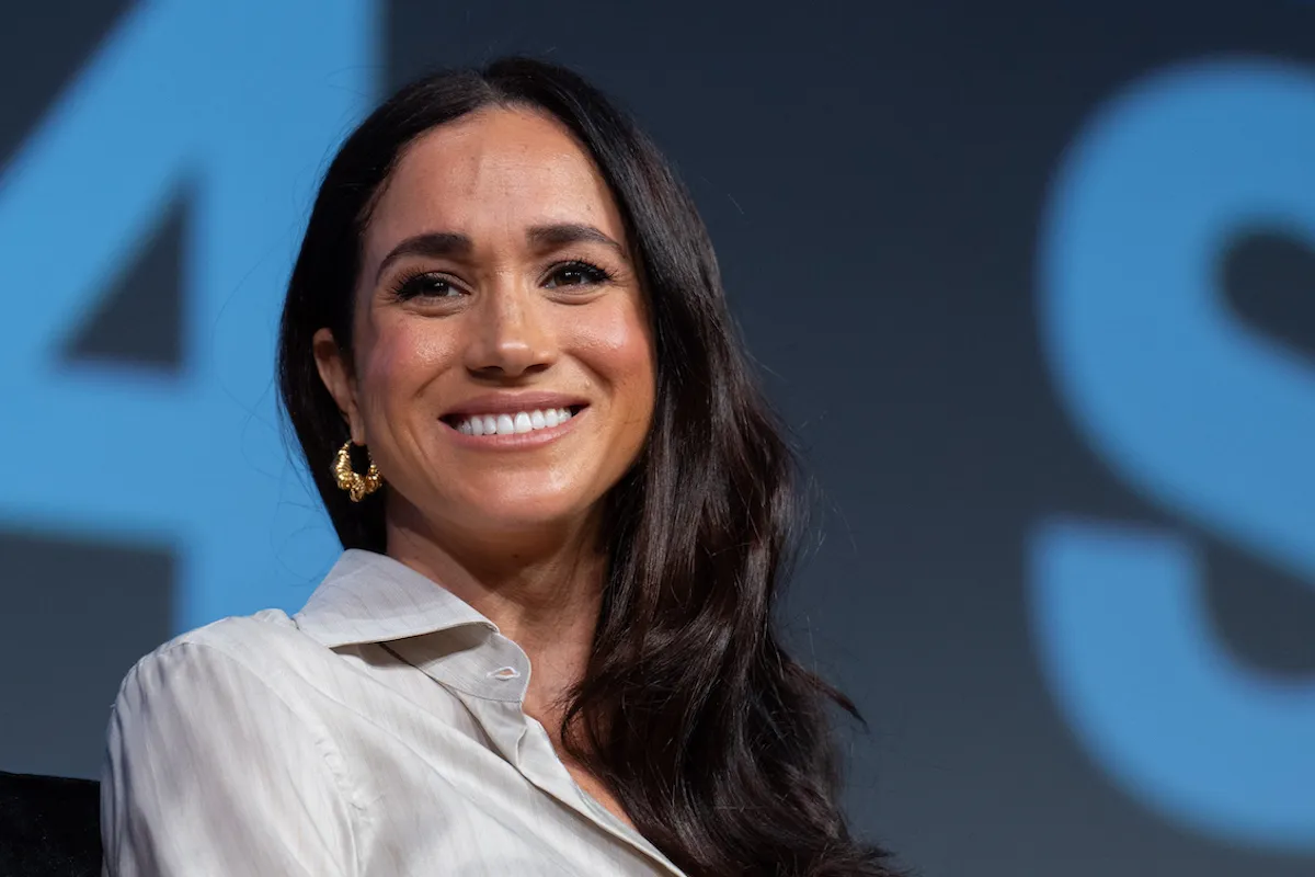 Meghan Markle, who is reportedly CEO of American Riviera Orchard, smiles and looks on