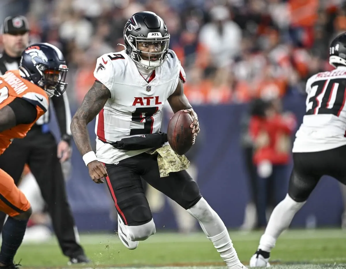 Michael Penix Jr. of the Atlanta Falcons scrambles in a game against the Denver Broncos