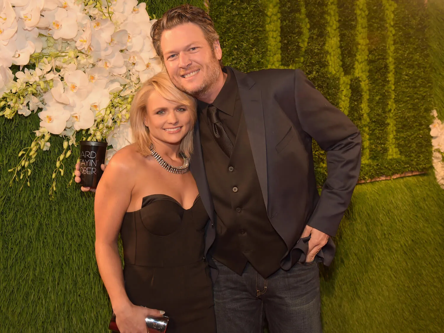 Miranda Lambert and Blake Shelton hugging and smiling at the camera in 2014