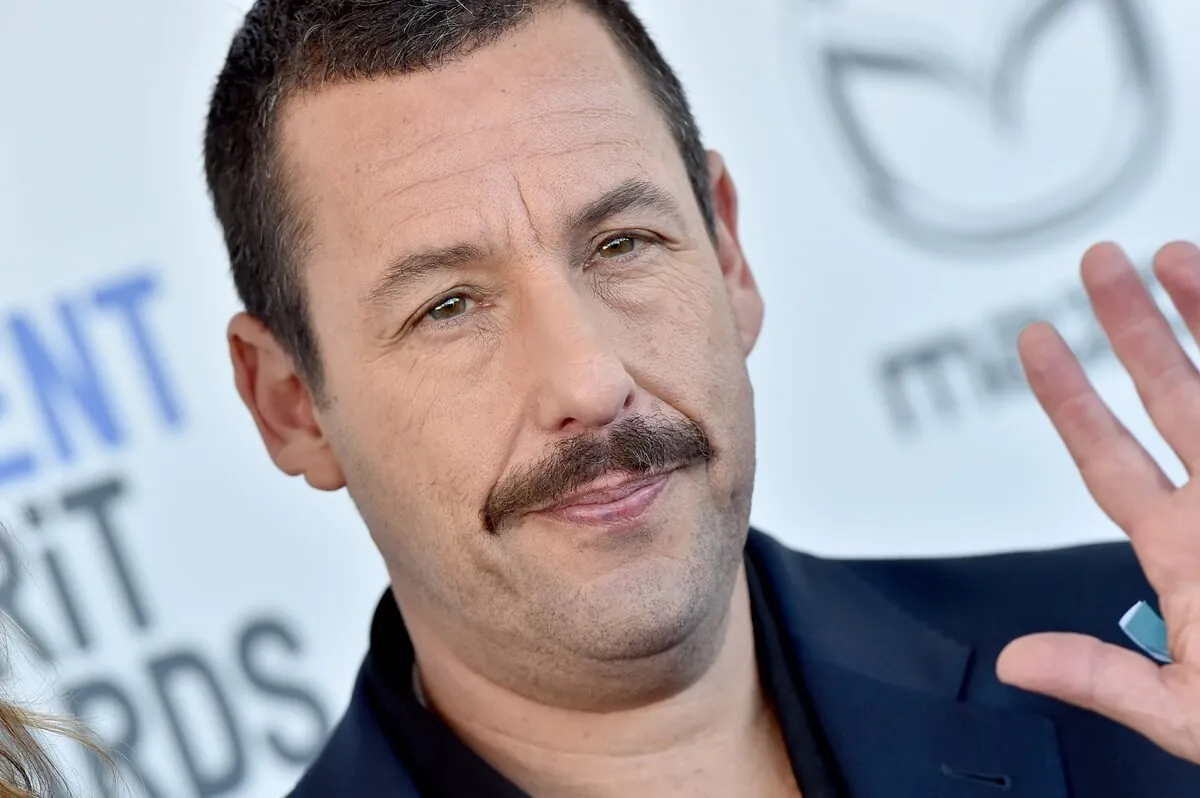 Adam Sandler attending the the 2020 Film Independent Spirit Awards in a dark blue blazer.