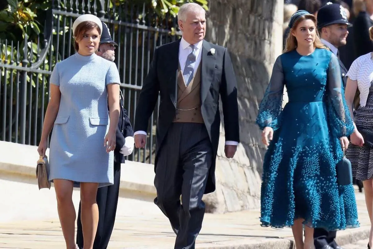 Prince Andrew, who has received a 'peace offering' in the form a Christmas invite from King Charles III, walks with  Princesses Eugenie and Beatrice